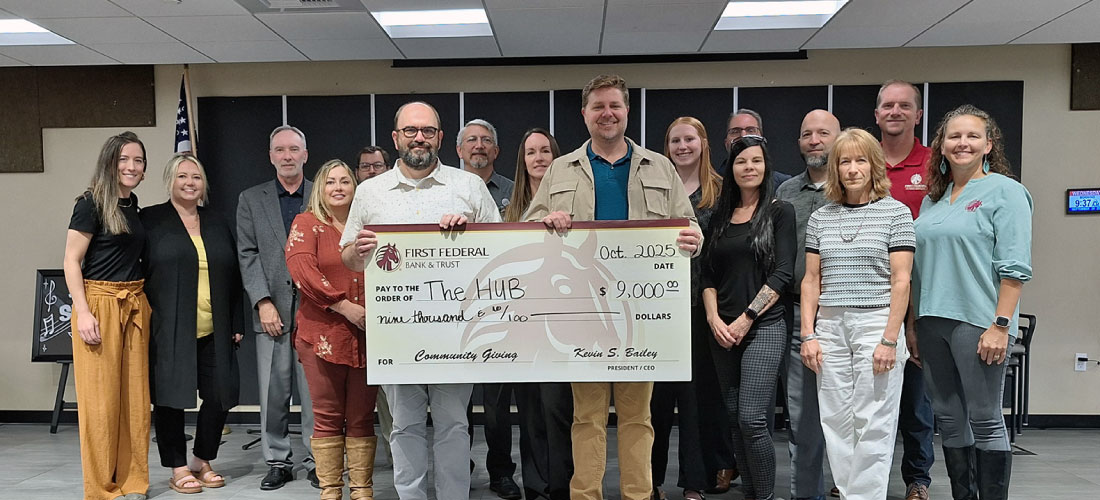 First Federal employees with members of the HUB and a $9000 donation check.