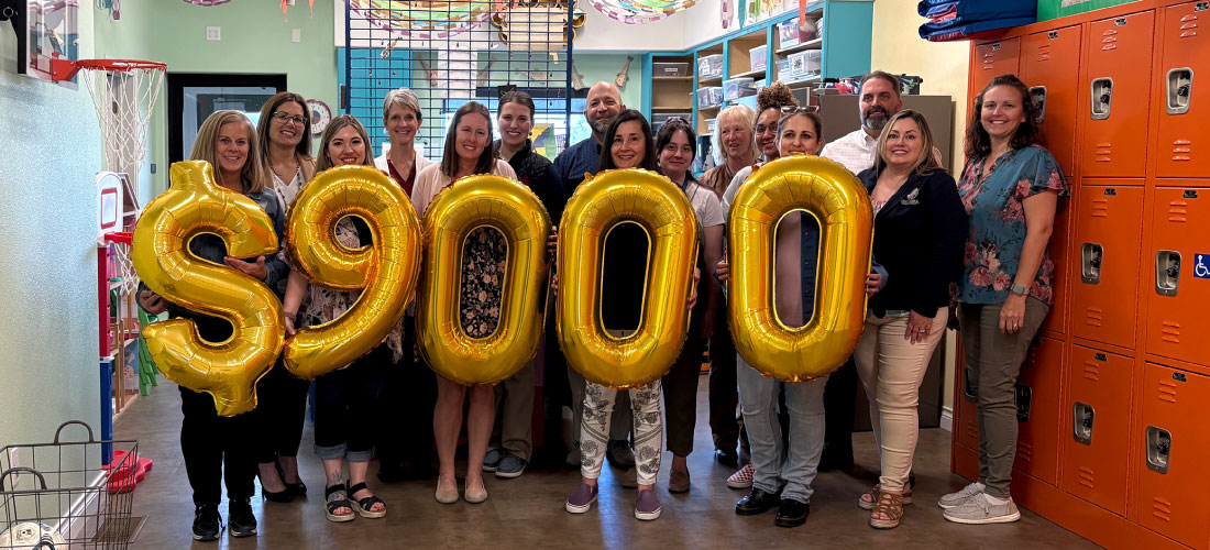 First Federal employees and Compass Center for Family members holding balloons.