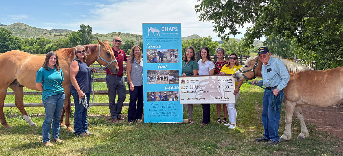 First Federal employees and members of CHAPS with their horses and a donation check.
