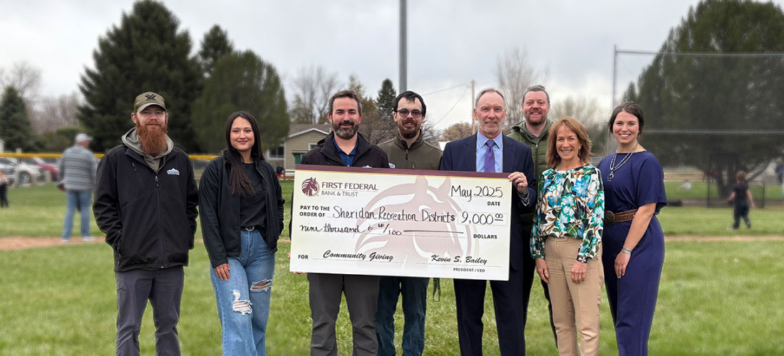 First Federal and Sheridan Rec employees holding a donation check.