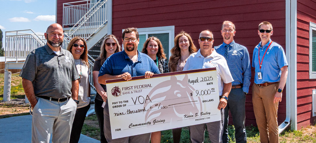 First Federal employees and members of the Sheridan VOA holding a donation check.