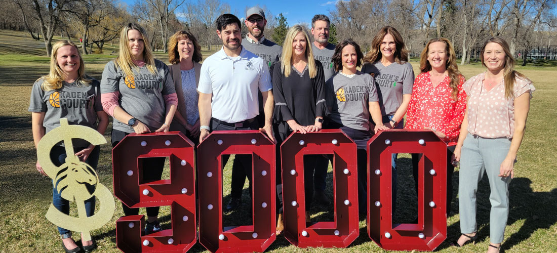 Group of First Federal employees and Partners for Parks members behind $9,000 marquee numbers.