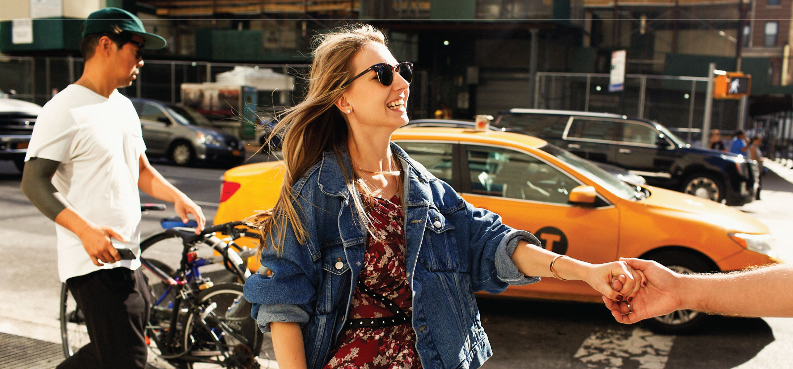 Happy woman holding hands enjoying the city.