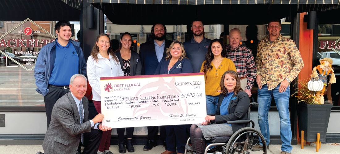 Group of people holding a donation check for the Sheridan College Foundation.