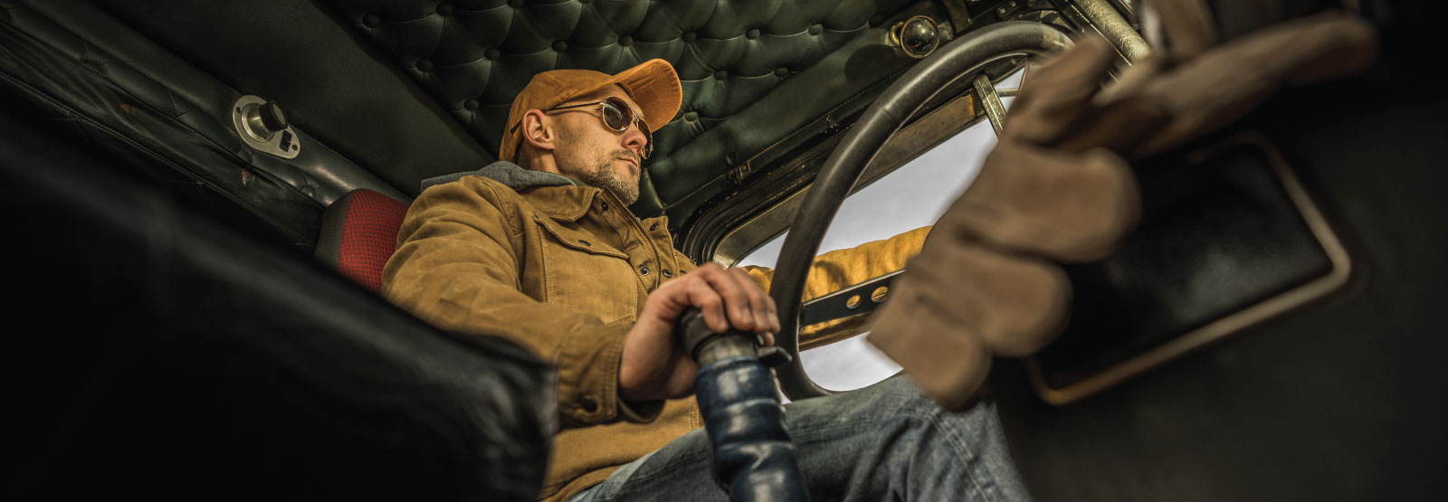 Man shifting gears in a semi truck.