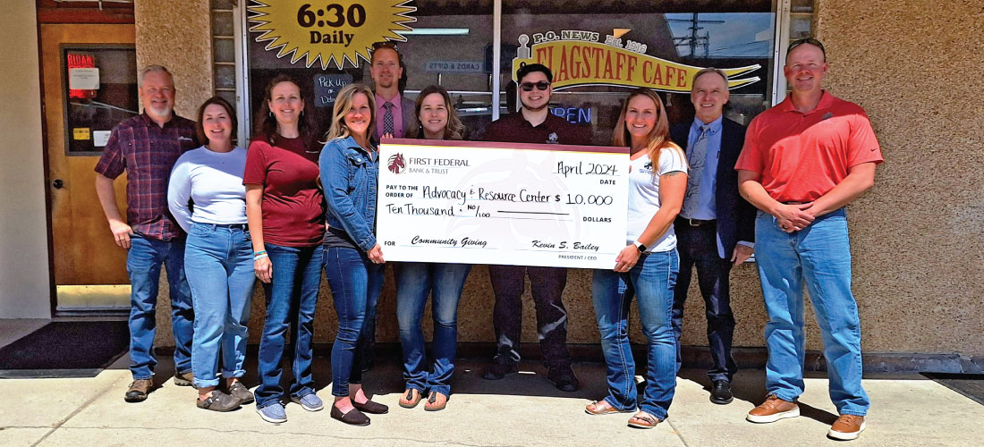 Group of people holding a donation check for the Advocacy & Resource Center.