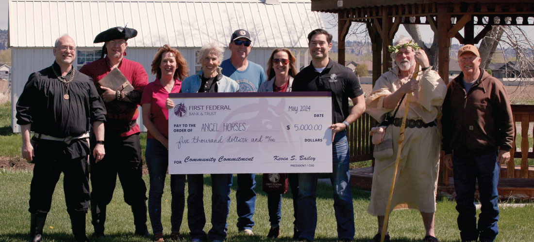 Group of people holding a donation check to Angel Horses.