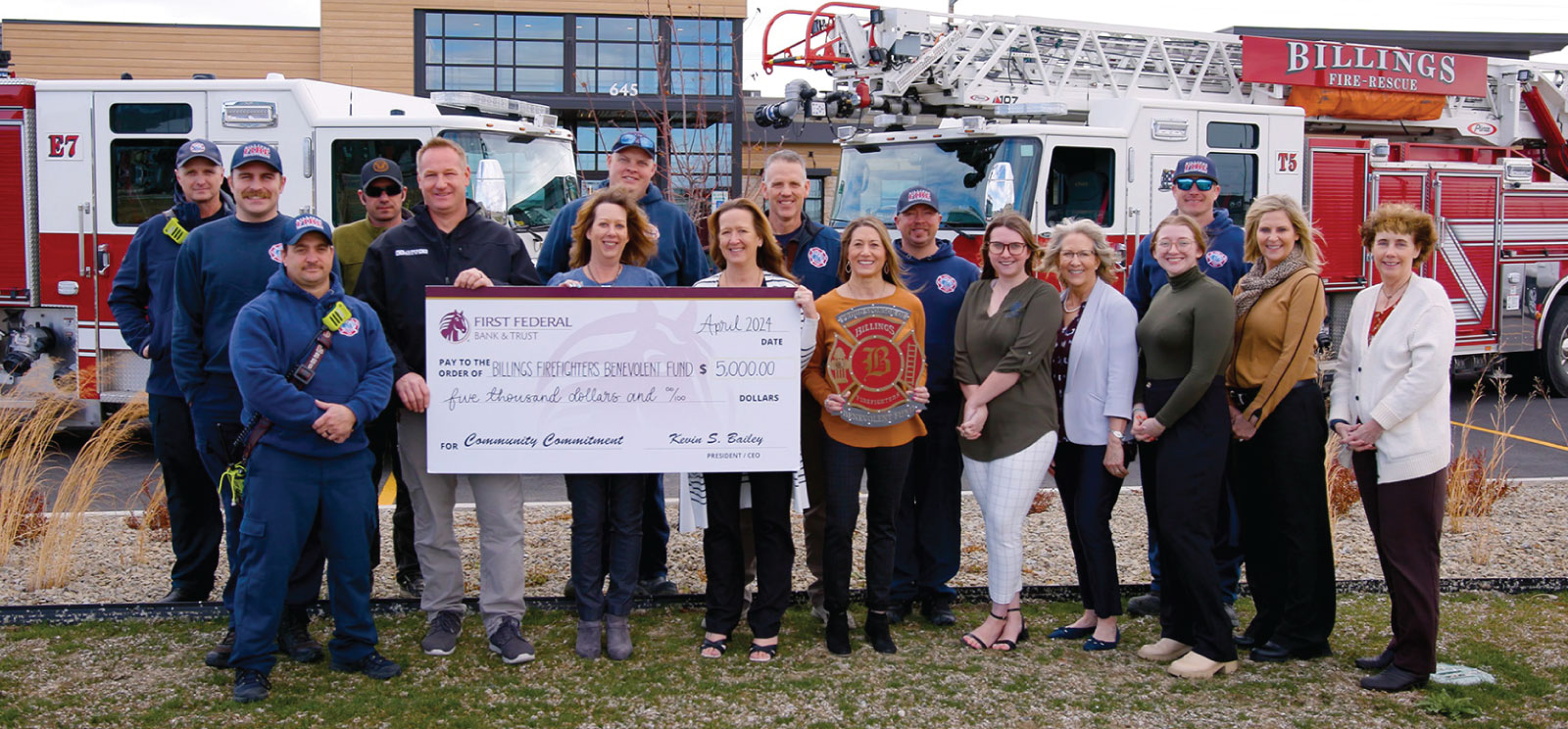 Group of First Federal employees and members of the Billings Firefighters Benevolent Fund holding a $5,000 donation check.