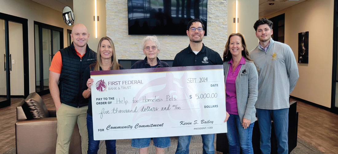 Group of people holding a donation check for Help For Homeless Pets